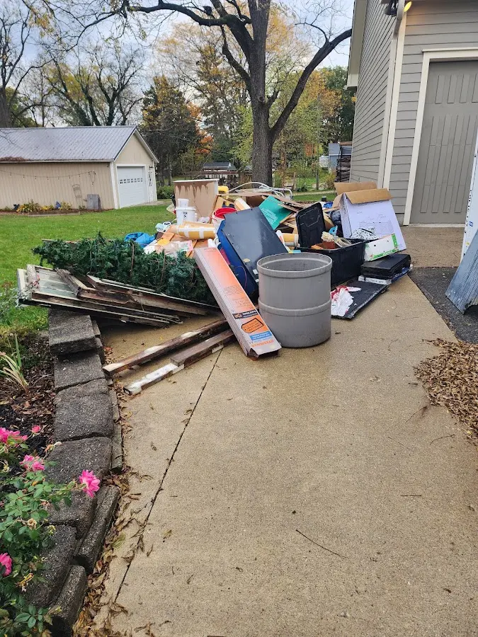 Dumpster being loaded with debris for Estate Cleanout Dumpster Rental in Danvers